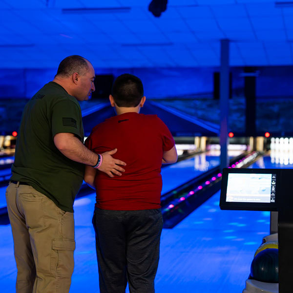 Youth Enjoying Cosmic Bowling